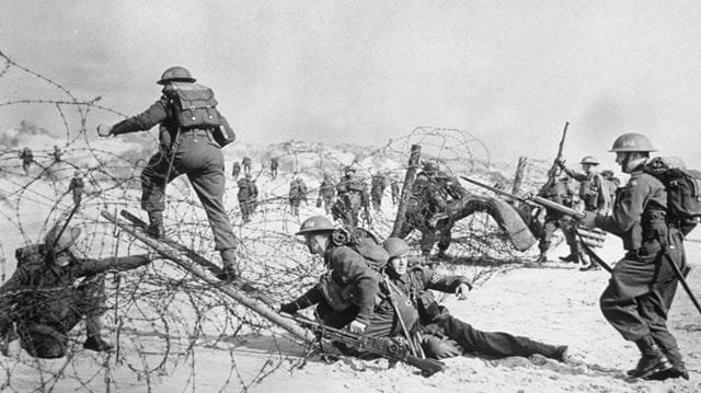 Soldiers carry out a training exercise across barbed wire